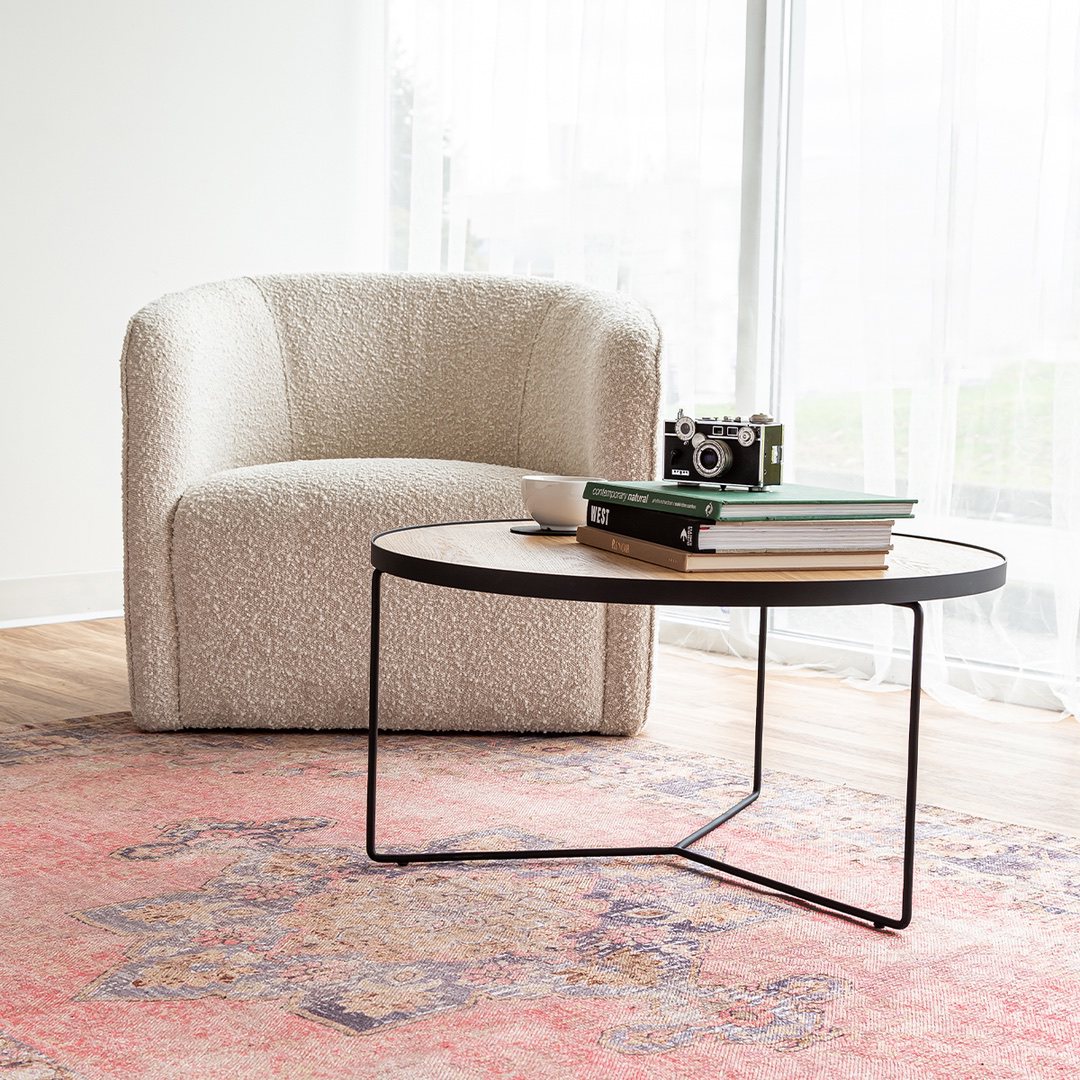 Evita cream boucle club chair with round coffee table in front