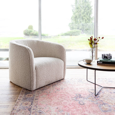 Evita Cream boucle chair in a living room with large windows
